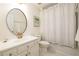 Bright bathroom featuring an oval mirror, shower/tub combo, and crisp white finishes at 1885 Oak Wind Ln, Buford, GA 30519