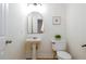 Powder room featuring a pedestal sink, toilet, and modern fixtures at 1885 Oak Wind Ln, Buford, GA 30519