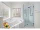 Bright bathroom featuring a corner tub and a separate glass-enclosed shower at 1885 Oak Wind Ln, Buford, GA 30519