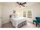 Cozy bedroom featuring large windows, a ceiling fan, and natural light at 1885 Oak Wind Ln, Buford, GA 30519