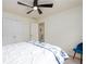 Bright bedroom featuring a ceiling fan, closet, and en-suite bathroom at 1885 Oak Wind Ln, Buford, GA 30519