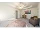Bright bedroom featuring tray ceiling, ceiling fan, and artful decor atop a dresser at 1885 Oak Wind Ln, Buford, GA 30519