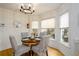Cozy eat-in kitchen nook with large windows and a modern chandelier at 1885 Oak Wind Ln, Buford, GA 30519