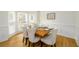 Bright dining room featuring wood floors, panel molding, and seating for six at a wooden table at 1885 Oak Wind Ln, Buford, GA 30519
