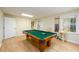Game room featuring pool table, wood-look floors, and natural light at 1885 Oak Wind Ln, Buford, GA 30519
