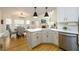 Eat-in kitchen features a breakfast bar, stainless steel appliances, and a view to the living area at 1885 Oak Wind Ln, Buford, GA 30519