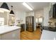 Bright, open kitchen featuring stainless steel appliances and a breakfast bar with pendant lighting at 1885 Oak Wind Ln, Buford, GA 30519
