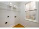 Laundry room featuring wire racks for storage and a window offering natural light at 1885 Oak Wind Ln, Buford, GA 30519