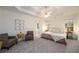 Spacious main bedroom with sitting area, tray ceiling, ceiling fan, and plush carpeting at 1885 Oak Wind Ln, Buford, GA 30519