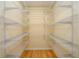 Walk-in pantry featuring ample wire rack storage space and hardwood floors at 1885 Oak Wind Ln, Buford, GA 30519