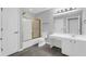 Updated bathroom with bright vanity, white cabinets, modern light fixture, and a combined shower-tub at 2191 Rockbridge Rd # 501, Stone Mountain, GA 30087