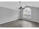 Spacious bedroom with vaulted ceilings, ceiling fan, and a large arched window at 2191 Rockbridge Rd # 501, Stone Mountain, GA 30087