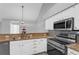 Kitchen features stainless steel appliances, granite countertops, and updated fixtures at 2191 Rockbridge Rd # 501, Stone Mountain, GA 30087