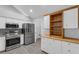 Well-lit kitchen boasts stainless steel appliances, a pantry, and modern finishes at 2191 Rockbridge Rd # 501, Stone Mountain, GA 30087