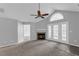 The open-concept living room has a cozy fireplace and french doors to sunroom at 2191 Rockbridge Rd # 501, Stone Mountain, GA 30087