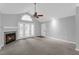 Spacious living room featuring a fireplace, French doors, ceiling fan, and neutral paint at 2191 Rockbridge Rd # 501, Stone Mountain, GA 30087