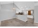 Open-concept living room features vaulted ceilings, updated lighting, and flows into the modern kitchen at 2191 Rockbridge Rd # 501, Stone Mountain, GA 30087