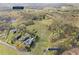 Aerial view of 22.19 acre lot featuring expansive green fields and woodlands with homes sparsely scattered nearby at 2210 Holly Springs Rd, Rockmart, GA 30153