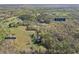 Aerial view showcasing a 22.19 acre lot with green fields, woodlands, and homes with a creek at 2210 Holly Springs Rd, Rockmart, GA 30153