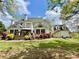 Back exterior showcasing a large backyard, mature trees and a multi-level deck and an outbuilding at 2210 Holly Springs Rd, Rockmart, GA 30153