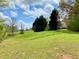 Expansive green backyard with mature trees, perfect for outdoor activities and relaxation at 2210 Holly Springs Rd, Rockmart, GA 30153