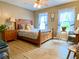Comfortable bedroom with hardwood floors, a large bed, and natural light at 2210 Holly Springs Rd, Rockmart, GA 30153