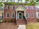 Charming two-story brick home with a welcoming front porch and landscaped front yard at 2210 Holly Springs Rd, Rockmart, GA 30153