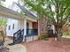 Side view of a brick house, complemented by a wooden porch and a well-maintained landscape at 2210 Holly Springs Rd, Rockmart, GA 30153