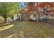Brick home with a well-maintained lawn, mature trees and shrubs along with a fenced yard at 2210 Holly Springs Rd, Rockmart, GA 30153