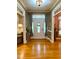 Elegant foyer featuring hardwood floors, decorative lighting, and access to adjacent living areas at 2210 Holly Springs Rd, Rockmart, GA 30153