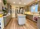 Stylish kitchen featuring modern appliances, grey cabinets, an island, and wood-look flooring at 2210 Holly Springs Rd, Rockmart, GA 30153