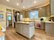 Kitchen island with grey cabinets and countertop with stainless steel refrigerator in background at 2210 Holly Springs Rd, Rockmart, GA 30153