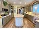 Bright, modern kitchen features stainless steel appliances, grey cabinets, an island, and wood-look flooring at 2210 Holly Springs Rd, Rockmart, GA 30153