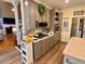 Open concept kitchen featuring stainless steel appliances, grey cabinets, gas range, and wood-look flooring at 2210 Holly Springs Rd, Rockmart, GA 30153