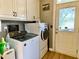 Laundry room with white washer and dryer and white cabinets at 2210 Holly Springs Rd, Rockmart, GA 30153