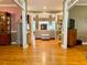 Open concept living room with hardwood floors, decorative columns, and a view of the back living area at 2210 Holly Springs Rd, Rockmart, GA 30153