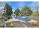 An in-ground pool is covered with a gazebo and patio furniture nearby, surrounded by mature trees and landscaping at 2210 Holly Springs Rd, Rockmart, GA 30153
