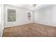 Spacious bedroom featuring two windows, neutral walls, ceiling fan, and comfortable brown carpet at 3651 Sapphire Ct, Decatur, GA 30034