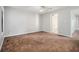 Bright bedroom with neutral walls, carpet, and baseboard trim, leading to a bathroom at 3651 Sapphire Ct, Decatur, GA 30034
