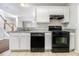 Functional kitchen with black appliances, tiled floors and white cabinets next to the dining area at 3651 Sapphire Ct, Decatur, GA 30034