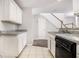 Well-lit kitchen with tile floors and a view of the staircase to the second story at 3651 Sapphire Ct, Decatur, GA 30034