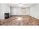 Spacious living room features plush carpeting, a ceiling fan, and a cozy fireplace at 3651 Sapphire Ct, Decatur, GA 30034