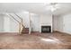 Cozy carpeted living room with a fireplace and stairs leading to the second floor at 3651 Sapphire Ct, Decatur, GA 30034
