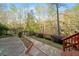 Beautifully landscaped backyard with stone pathway, black metal fence and gate, and mature trees at 4002 Moheb Sw St, Atlanta, GA 30331