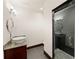 Bathroom featuring granite counters, modern vanity, tile floors, and glass shower door at 4002 Moheb Sw St, Atlanta, GA 30331