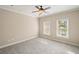 Neutral bedroom with a ceiling fan and two windows allowing ample natural light at 4002 Moheb Sw St, Atlanta, GA 30331