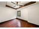 Bedroom features dark trim, hardwood floors, tray ceiling, and a window at 4002 Moheb Sw St, Atlanta, GA 30331