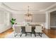 Formal dining room with a modern chandelier, hardwood floors, and elegant furnishings at 4002 Moheb Sw St, Atlanta, GA 30331