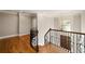 Elegant upstairs hallway with hardwood floors and decorative wrought iron railing at 4002 Moheb Sw St, Atlanta, GA 30331