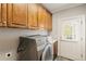 Laundry room featuring wooden cabinets, washer/dryer, and back door at 4002 Moheb Sw St, Atlanta, GA 30331